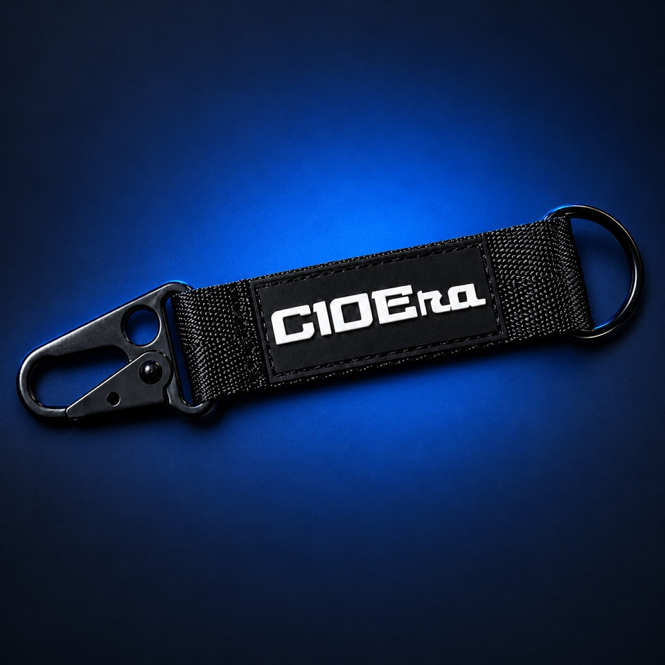 C10 Era Snap Strap Keychain, black webbing strap with stitched white C10 Era patch, matte black snap clip and key ring
